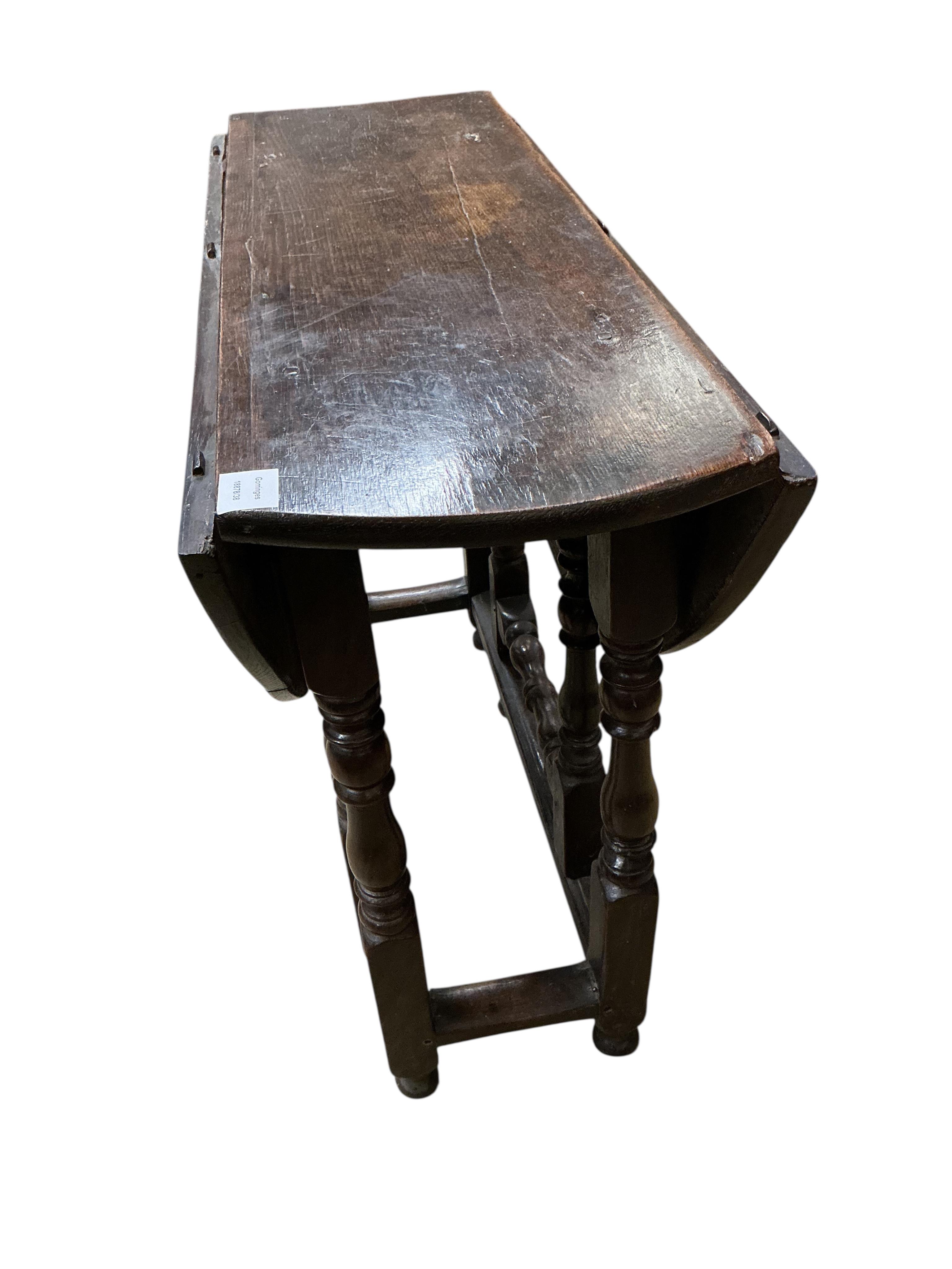 A small 18th century oval oak gate-legged table, width 92cm, depth 36cm, height 75cm